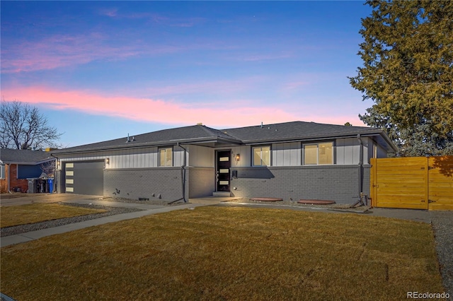 view of front of home featuring a yard and a garage