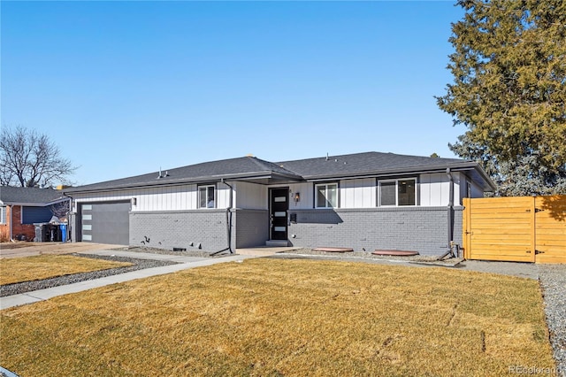 view of front of house with a garage and a front lawn