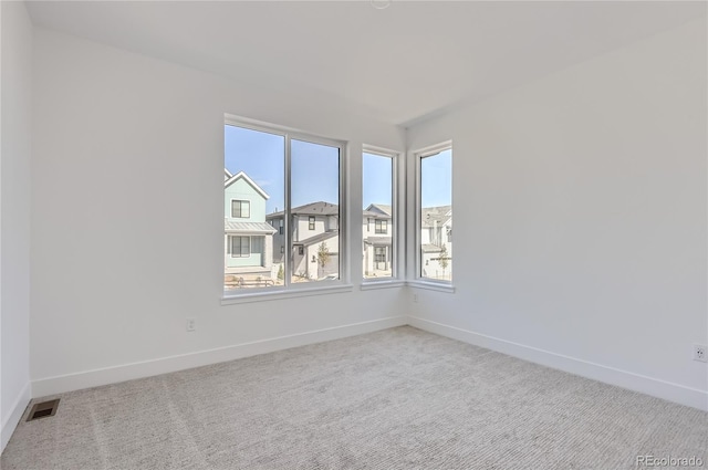 spare room with light colored carpet