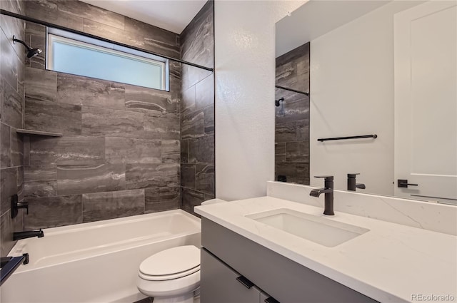 full bathroom with tiled shower / bath combo, vanity, and toilet