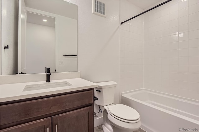 full bathroom featuring tiled shower / bath combo, vanity, and toilet