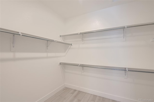 spacious closet featuring light wood-type flooring