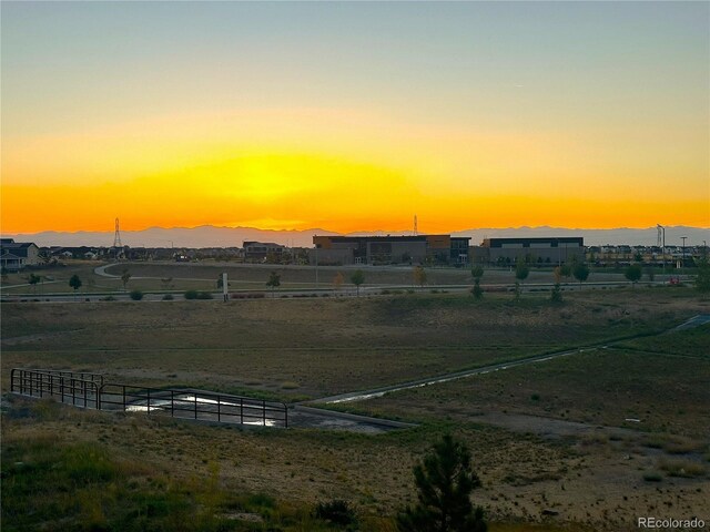 yard at dusk featuring a mountain view