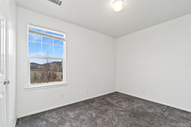 unfurnished room with dark carpet