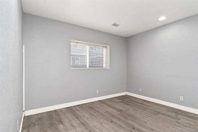 spare room with hardwood / wood-style floors