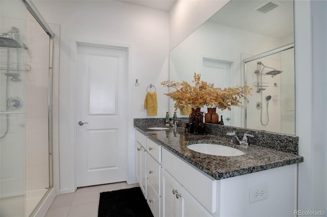 bathroom featuring vanity, tile patterned floors, and walk in shower