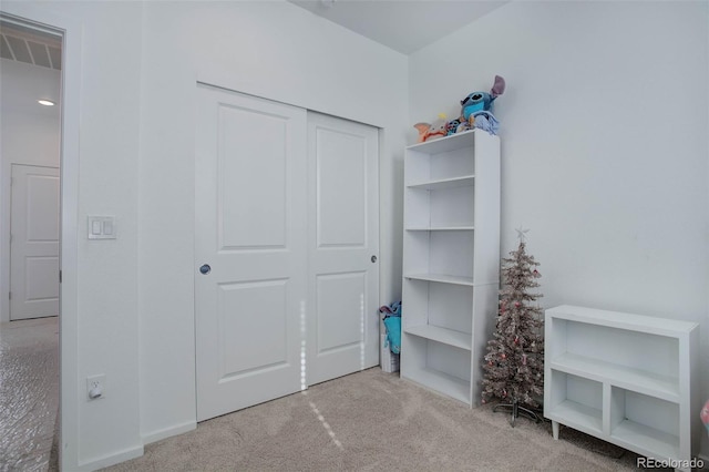 bedroom featuring a closet and light colored carpet