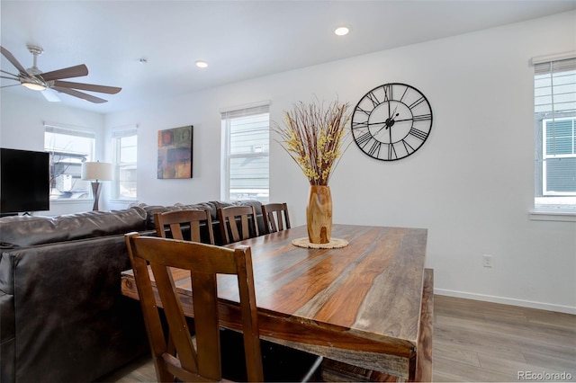 dining room featuring a ceiling fan, recessed lighting, baseboards, and light wood finished floors