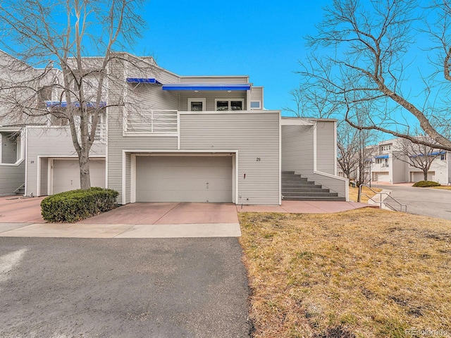 view of front of house with concrete driveway and a front lawn