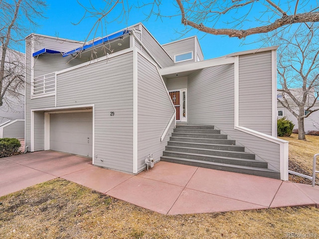 view of side of property featuring a garage and driveway