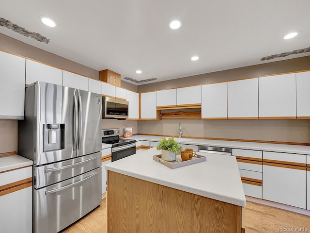 kitchen featuring light wood-style floors, appliances with stainless steel finishes, and light countertops