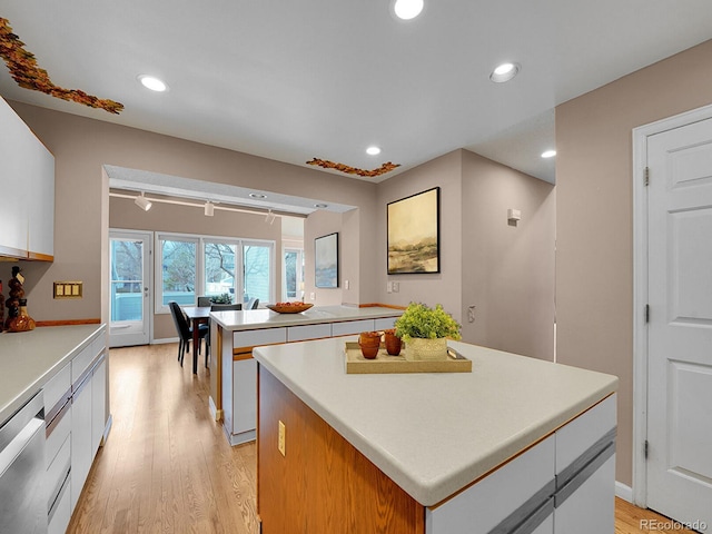 kitchen featuring a center island, light wood-style flooring, stainless steel dishwasher, and recessed lighting