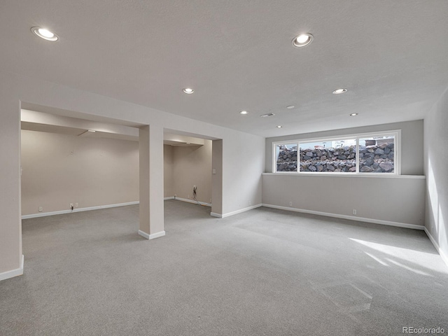 below grade area with baseboards, carpet flooring, and recessed lighting