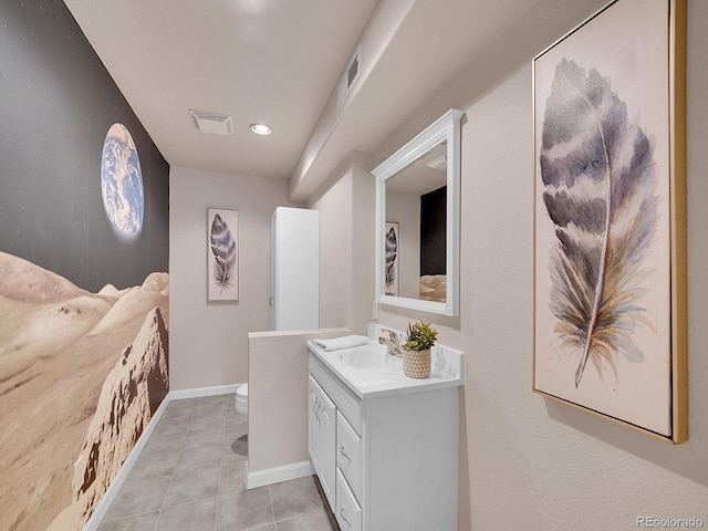 bathroom with visible vents, vanity, toilet, and tile patterned floors