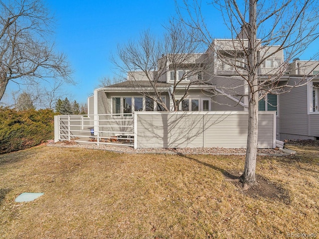 view of side of home with a yard and fence