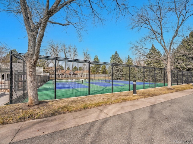 view of sport court featuring fence