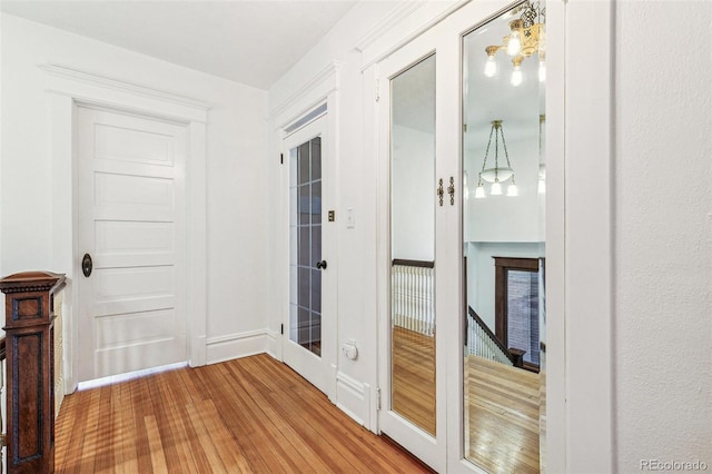 interior space featuring baseboards and wood finished floors