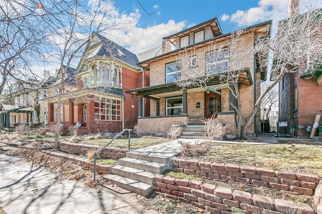 traditional style home featuring brick siding and a porch