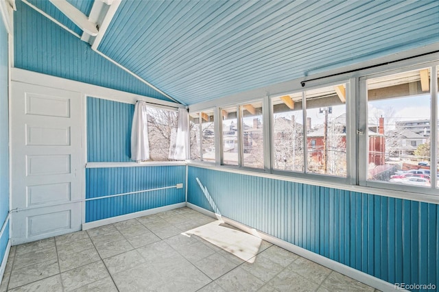 unfurnished sunroom featuring vaulted ceiling