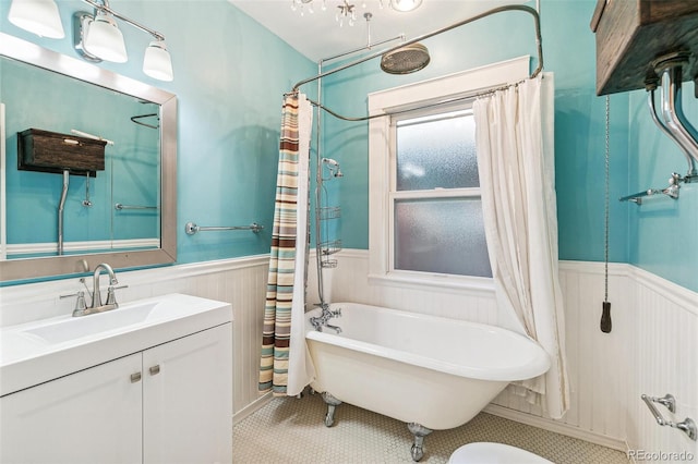 full bath with wainscoting, a tub, curtained shower, tile patterned flooring, and vanity