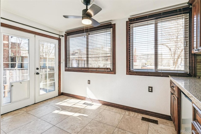 interior space featuring plenty of natural light, baseboards, ceiling fan, and light tile patterned flooring