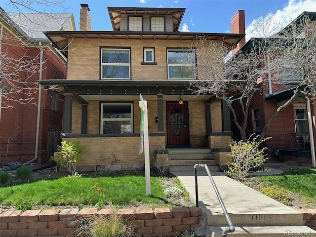 traditional style home featuring a chimney, a porch, and brick siding