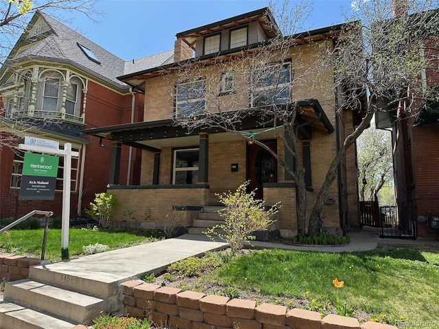 view of front of house with covered porch and brick siding