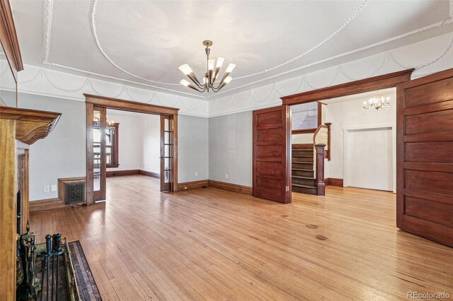 1451 N Gilpin St, Denver, CO 80218 - unfurnished living room with a chandelier, light wood-style flooring, and stairway