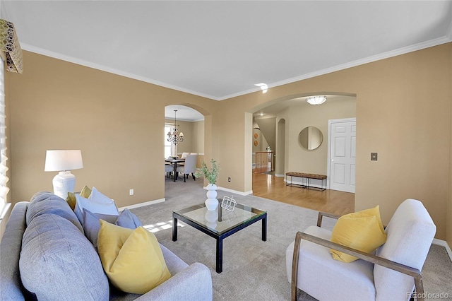 living room featuring light hardwood / wood-style flooring, an inviting chandelier, and ornamental molding