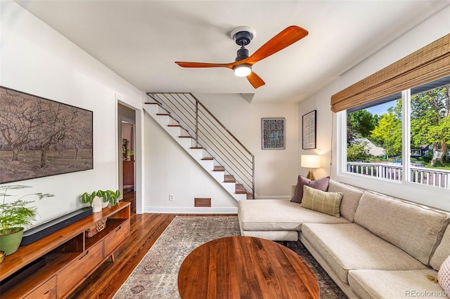 2535 S Julian St, Denver, CO 80219 - living room featuring dark wood-style flooring, a ceiling fan, stairs, and baseboards