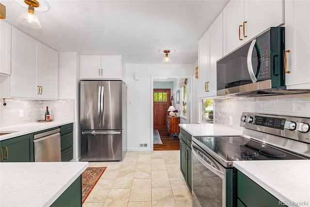 2535 S Julian St, Denver, CO 80219 - kitchen featuring appliances with stainless steel finishes, green cabinets, white cabinetry, and backsplash