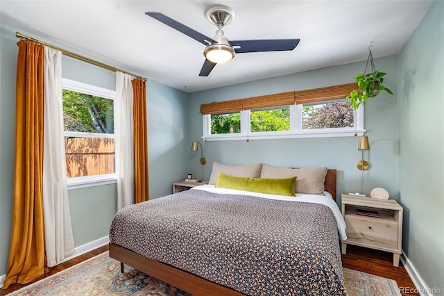 2535 S Julian St, Denver, CO 80219 - bedroom featuring multiple windows, wood finished floors, baseboards, and a ceiling fan