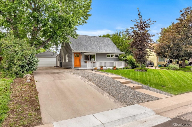 2535 S Julian St, Denver, CO 80219 - view of front of property featuring covered porch, an outbuilding, a front yard, a garage, and roof with shingles