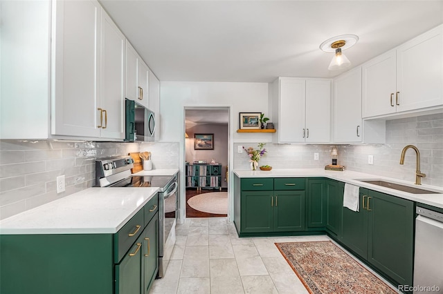 2535 S Julian St, Denver, CO 80219 - kitchen with green cabinets, appliances with stainless steel finishes, a sink, and white cabinetry