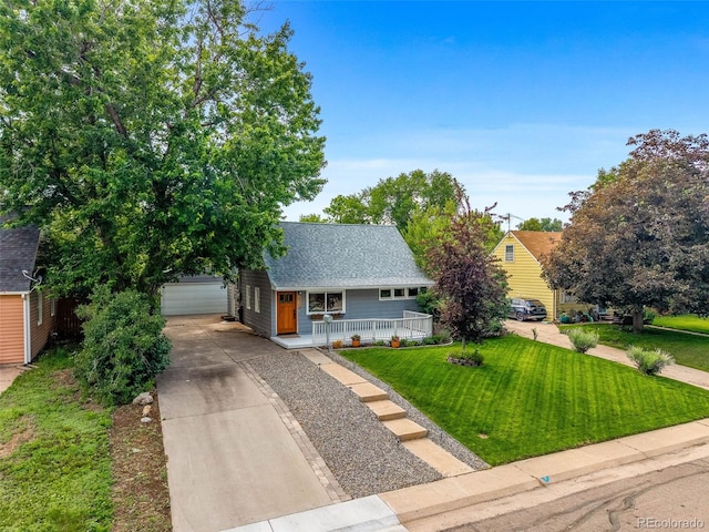 2535 S Julian St, Denver, CO 80219 - view of front of house with a porch, an outbuilding, a front lawn, a shingled roof, and a detached garage