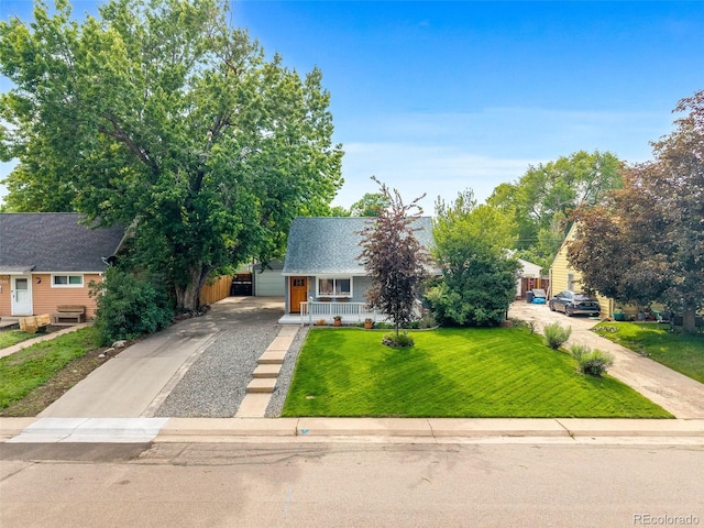 2535 S Julian St, Denver, CO 80219 - view of front facade with driveway, a porch, and a front lawn