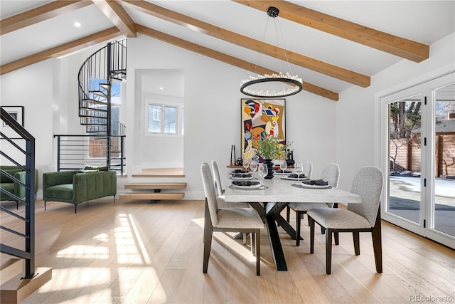 dining space with vaulted ceiling with beams, light hardwood / wood-style flooring, and an inviting chandelier