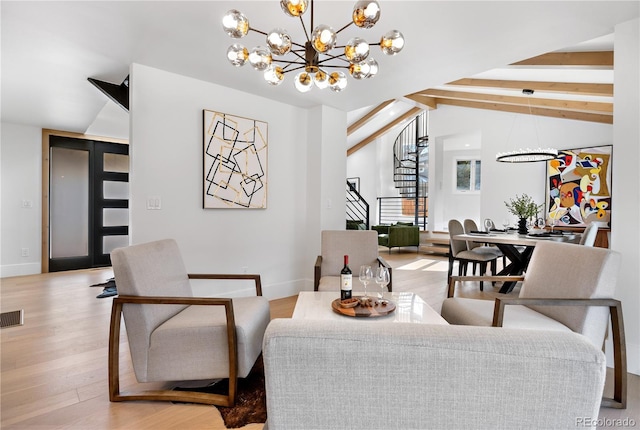 living room featuring lofted ceiling with beams, light hardwood / wood-style flooring, and a chandelier