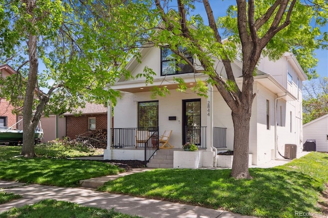 2844 Quitman St, Denver, CO 80212 - view of front of home featuring central AC, a front yard, and a porch