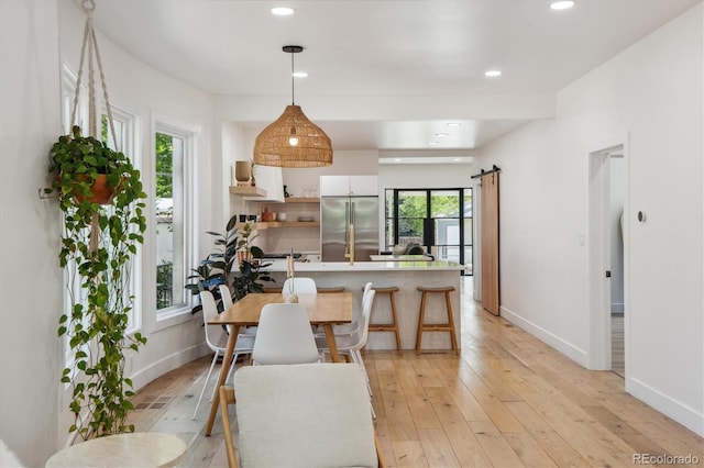2844 Quitman St, Denver, CO 80212 - dining room featuring light wood-style flooring, baseboards, a barn door, and recessed lighting