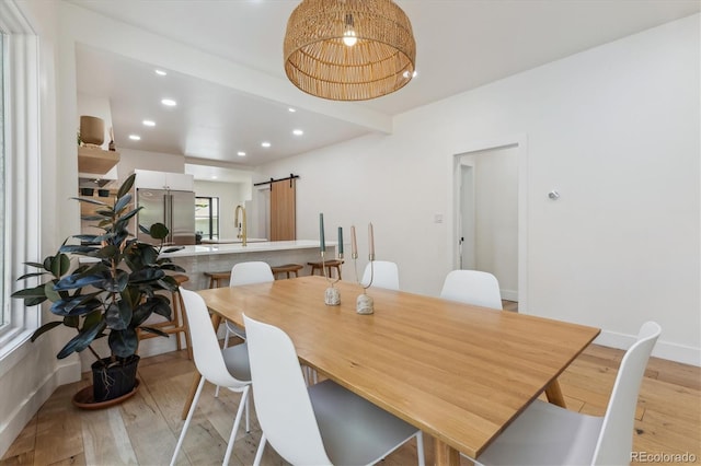 2844 Quitman St, Denver, CO 80212 - dining space featuring light wood-style floors, a barn door, and recessed lighting