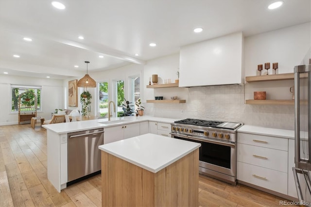 2844 Quitman St, Denver, CO 80212 - kitchen featuring appliances with stainless steel finishes, open shelves, light countertops, a sink, and recessed lighting