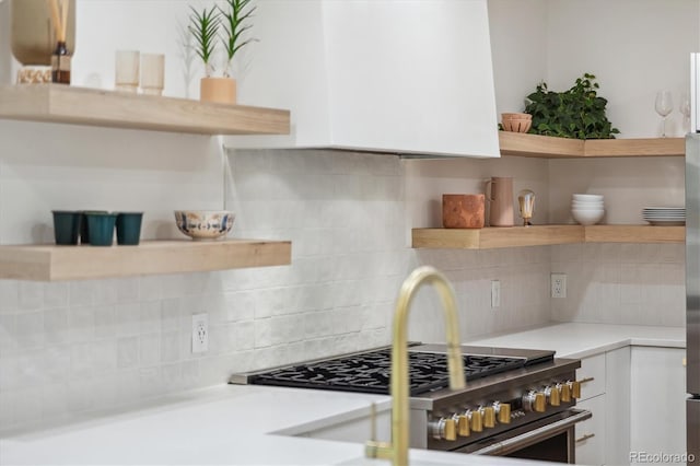 2844 Quitman St, Denver, CO 80212 - kitchen featuring open shelves, white cabinets, tasteful backsplash, light countertops, and high end stainless steel range oven