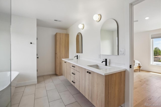2844 Quitman St, Denver, CO 80212 - full bath featuring a soaking tub, double vanity, and baseboards