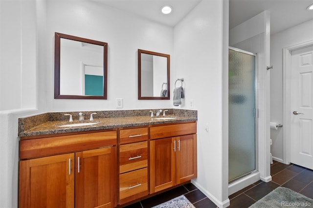 bathroom with toilet, walk in shower, and vanity