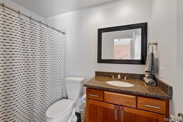 bathroom with curtained shower, toilet, and vanity