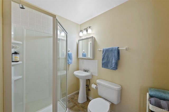 bathroom featuring walk in shower, sink, and toilet