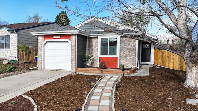 single story home featuring fence, an attached garage, driveway, and brick siding