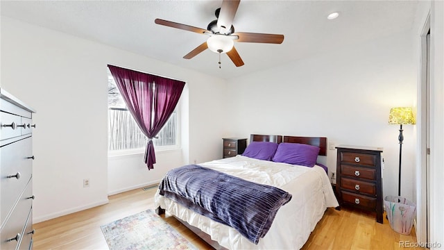 bedroom featuring light wood-style flooring, a ceiling fan, baseboards, recessed lighting, and visible vents