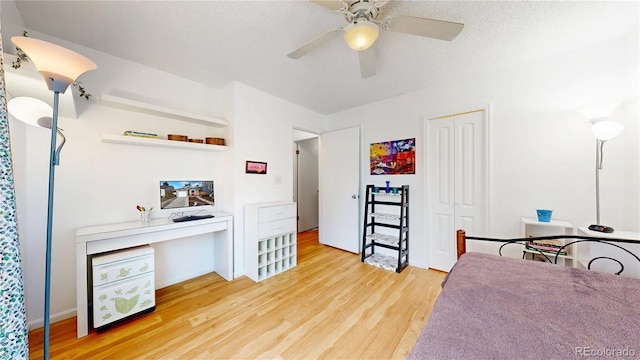 bedroom with a closet, a ceiling fan, and light wood finished floors